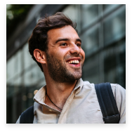Smiling man with white shirt and backpack
